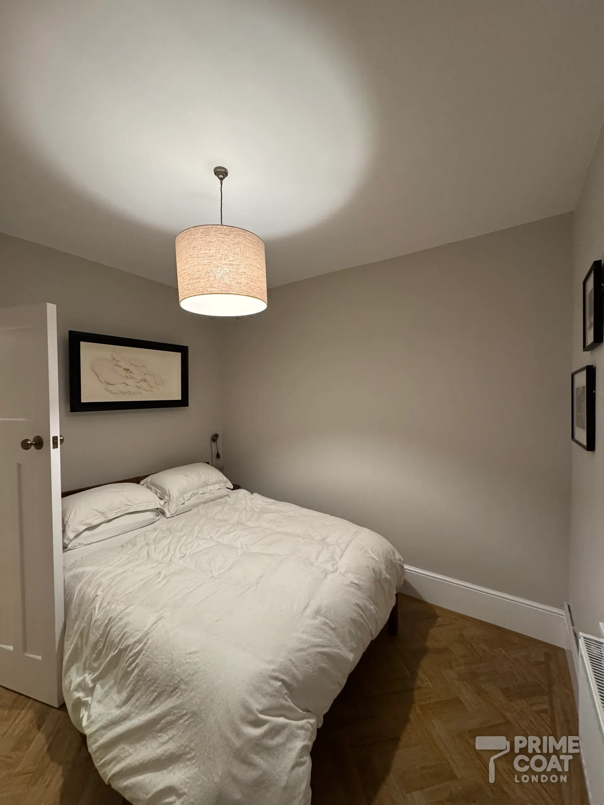 Second bedroom of a Battersea SW11 period flat after repainting — soft grey walls and a fresh white ceiling above the parquet floor