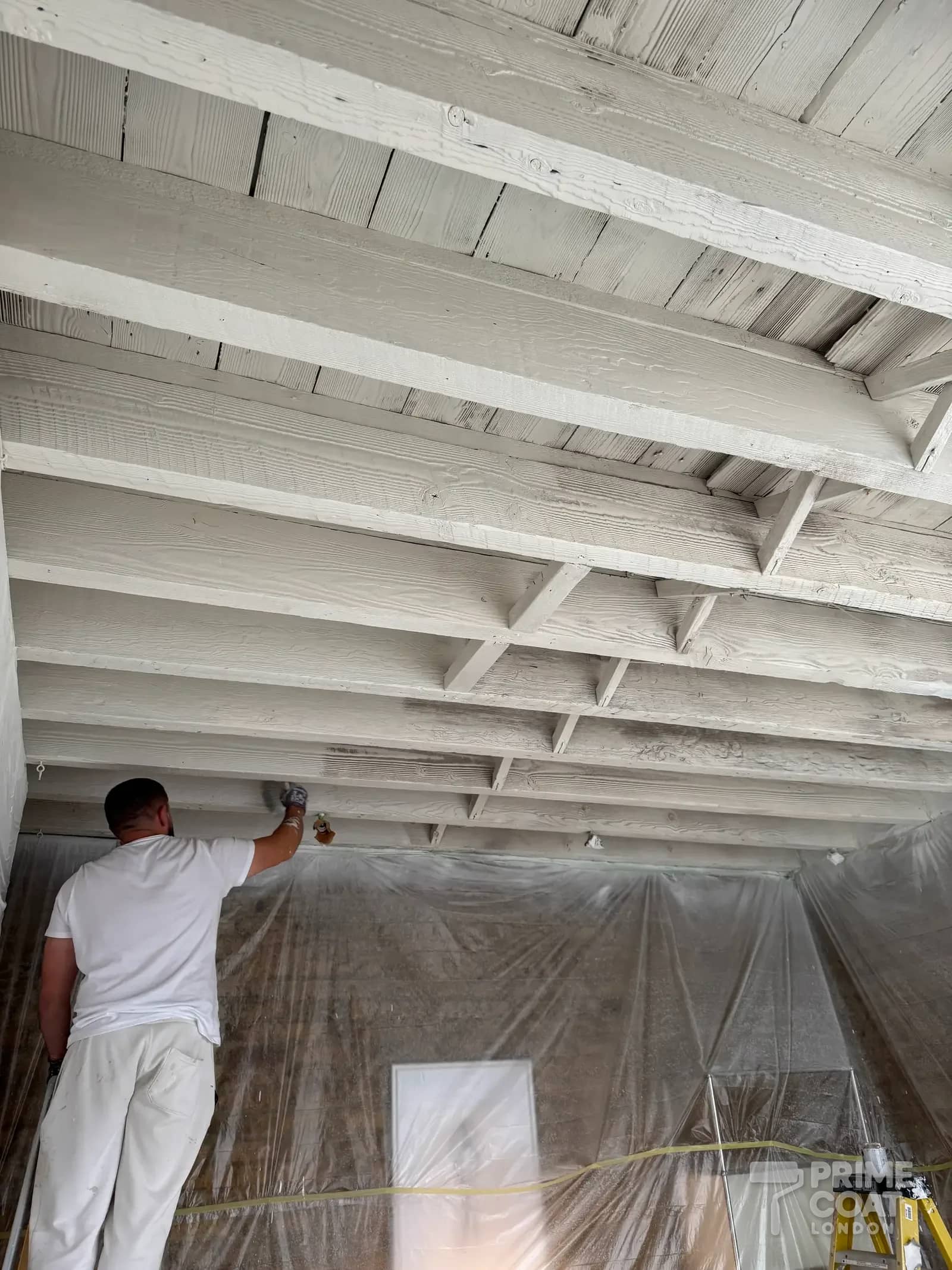 Shoreditch E2 timber ceiling sealed with hand-brushed Zinsser B-I-N primer, joists and boards turned white over the dark timber