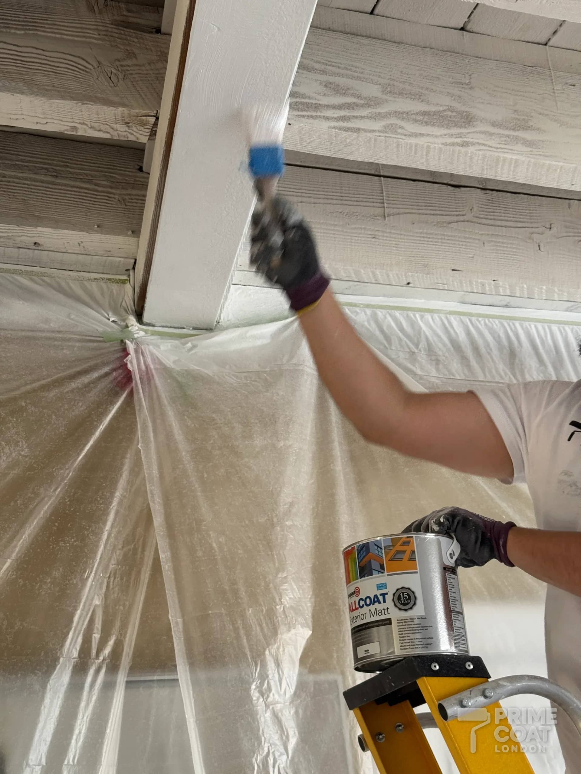 Beam in a Shoreditch E2 loft being brush-painted with Zinsser AllCoat Exterior Matt in white